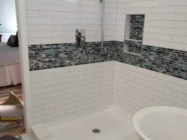 Custom tile shower with mosaic accent stripe and built-in niche — master bathroom remodel in Estacada, OR by Devine Home Remodeling & Construction