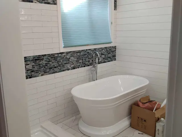 Freestanding soaking tub with subway tile and glass mosaic accents — Estacada, OR bathroom remodel by Devine Home Remodeling & Construction