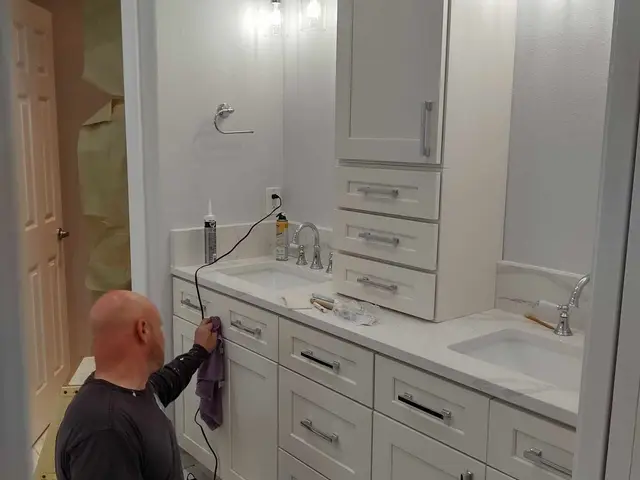 Custom double-sink vanity with quartz countertop and tower cabinet — bathroom remodel near Estacada, OR by Devine Home Remodeling & Construction