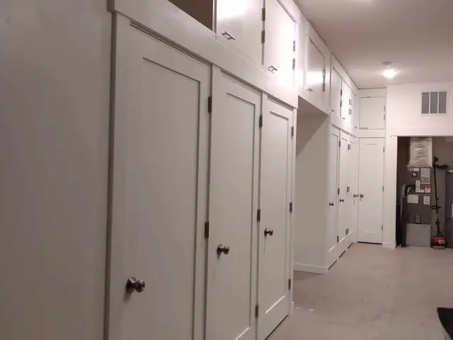 Custom floor-to-ceiling white shaker built-in storage cabinetry in Estacada, OR — Devine Home Remodeling & Construction