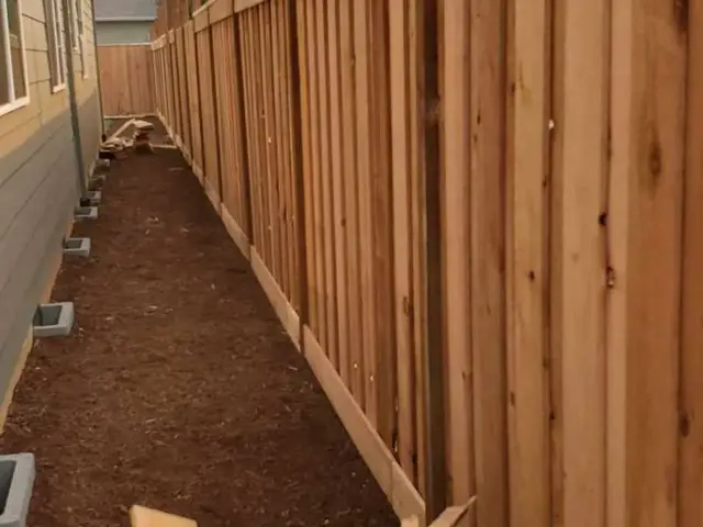 Cedar privacy fence under construction along a side yard near Estacada, OR — Devine Home Remodeling & Construction