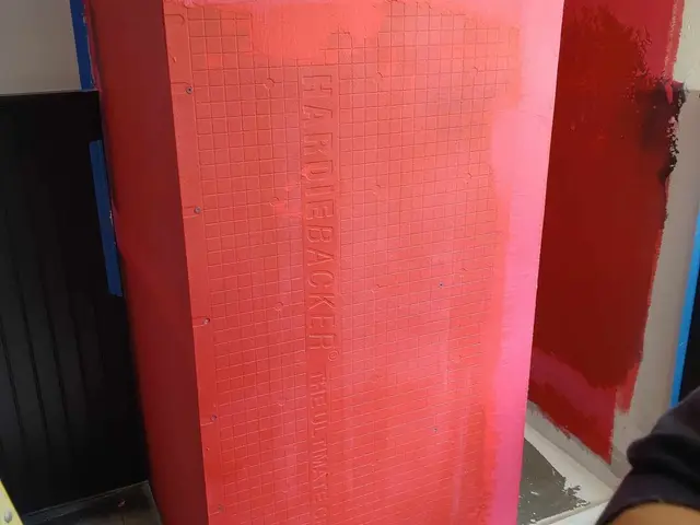 Red liquid waterproofing membrane rolled over shower walls in Estacada, OR — Devine Home Remodeling & Construction