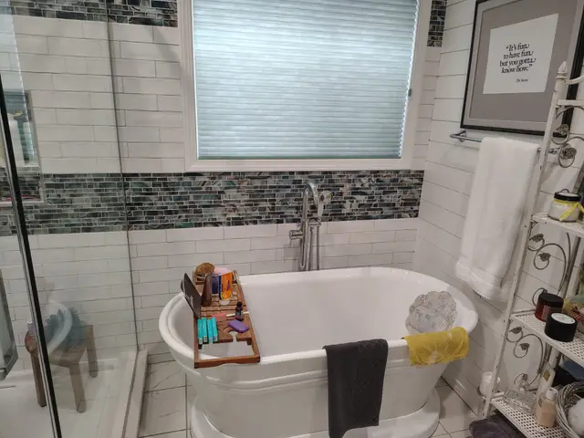 Freestanding soaking tub beside a custom tiled shower in a remodeled primary bathroom near Estacada, OR — Devine Home Remodeling & Construction