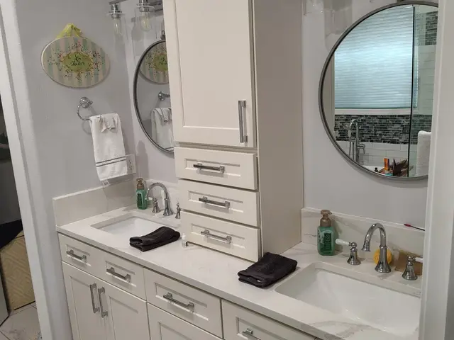 Custom double-sink vanity with center tower cabinet and quartz countertops near Estacada, OR — Devine Home Remodeling & Construction